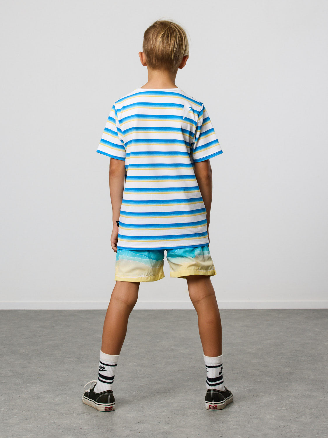 Radicool Kids beach stripe tee: Cotton / spandex tee in white with beach waves printed in horizontal stripes. Radicool Dude badge on chest. We love a stripe, even more when it’s the colours of the beach! Fit is true to size.
