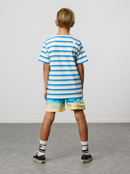 Radicool Kids beach stripe tee: Cotton / spandex tee in white with beach waves printed in horizontal stripes. Radicool Dude badge on chest. We love a stripe, even more when it’s the colours of the beach!  Fit is true to size.